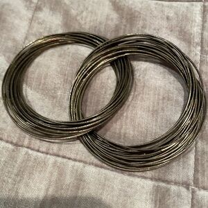 Two Interlocking Bundles of Bangle Bracelets